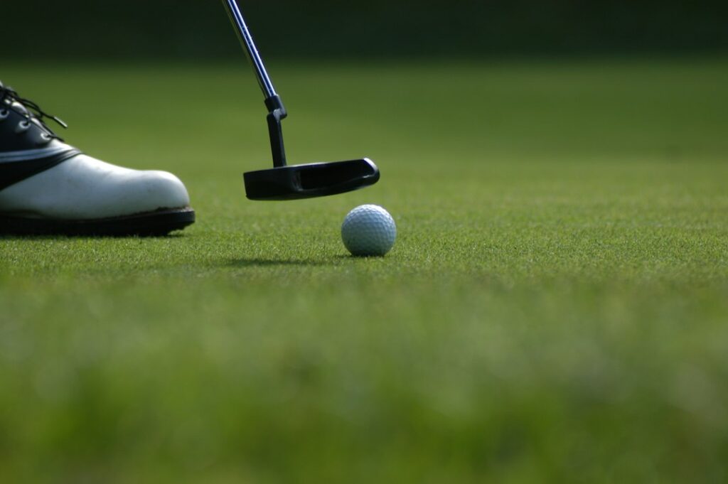 Golf ball rolling on putting green
