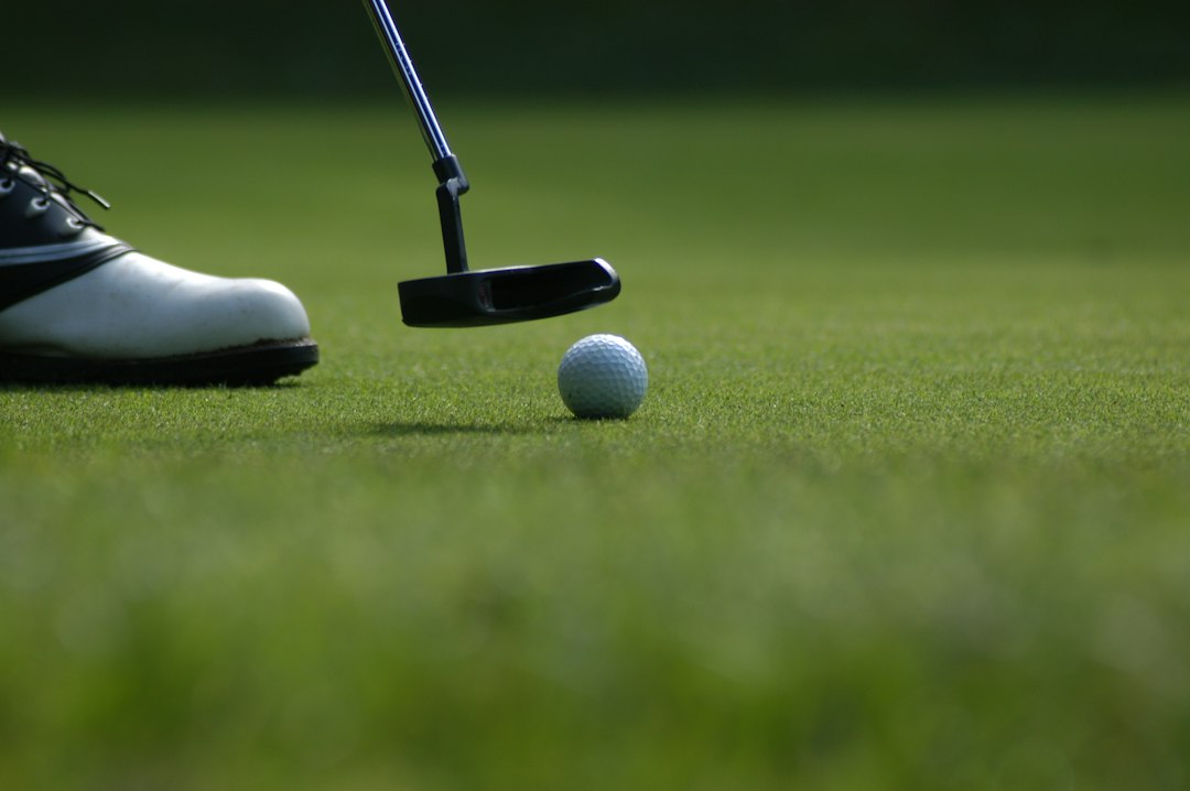 Golf ball near a hole on a putting green