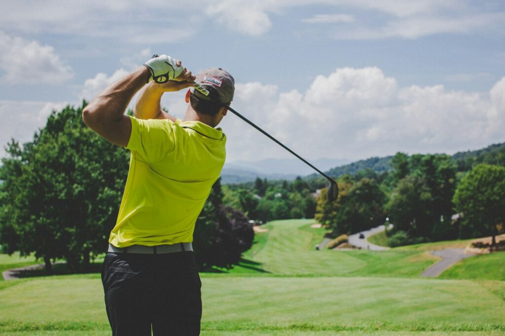 Golfer making a full swing outdoors