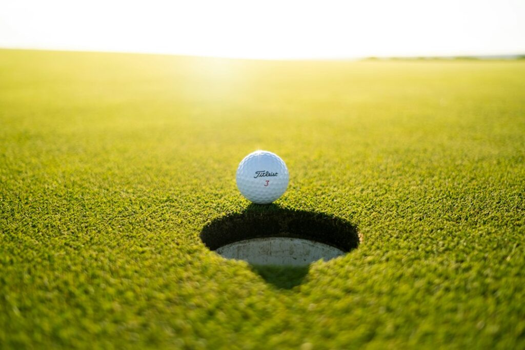 White golf ball on a green grassy surface
